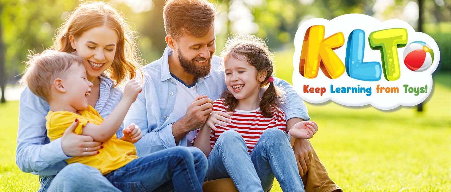 A family laughing in the park beside the KLT Keep Learning from Toys logo